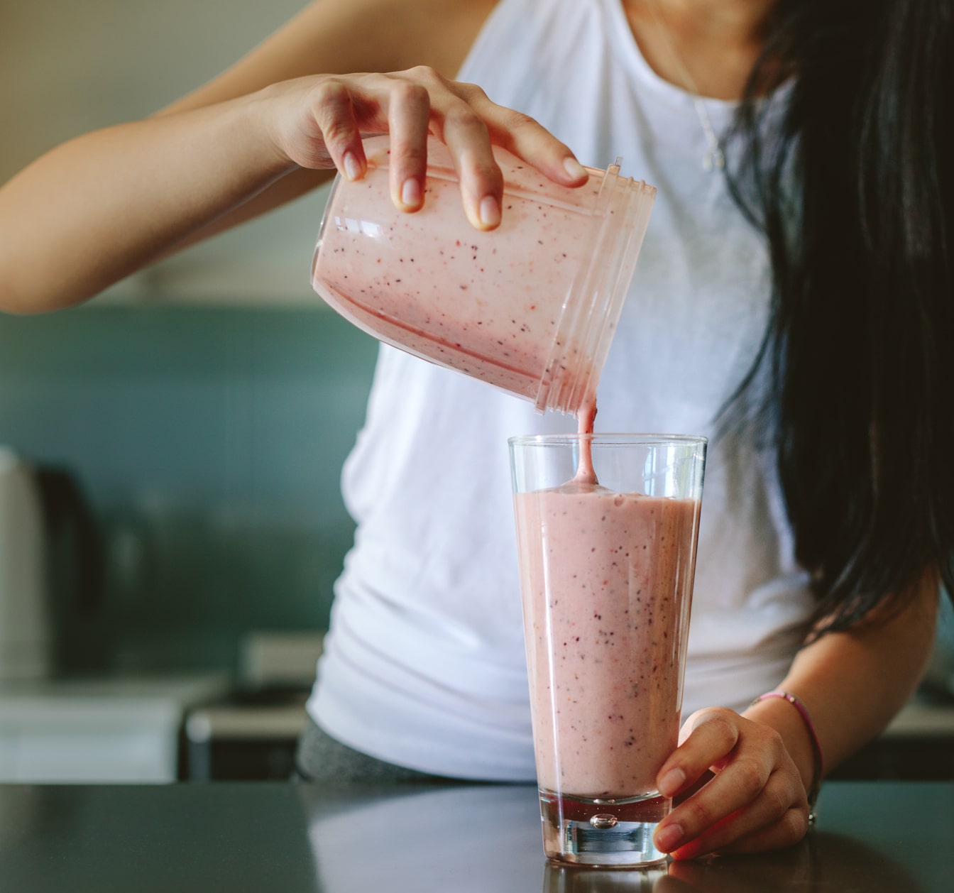 Woman pouring a milkshake from a blender